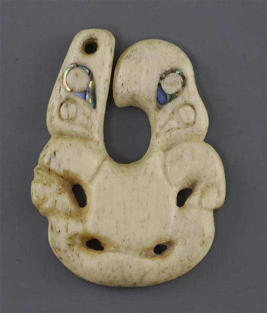 A rare Maori whale bone and paua shell pendant, hei tiki of unusual hei matau form, possibly late 18th/early 19th century, H. 8.8cm, sh